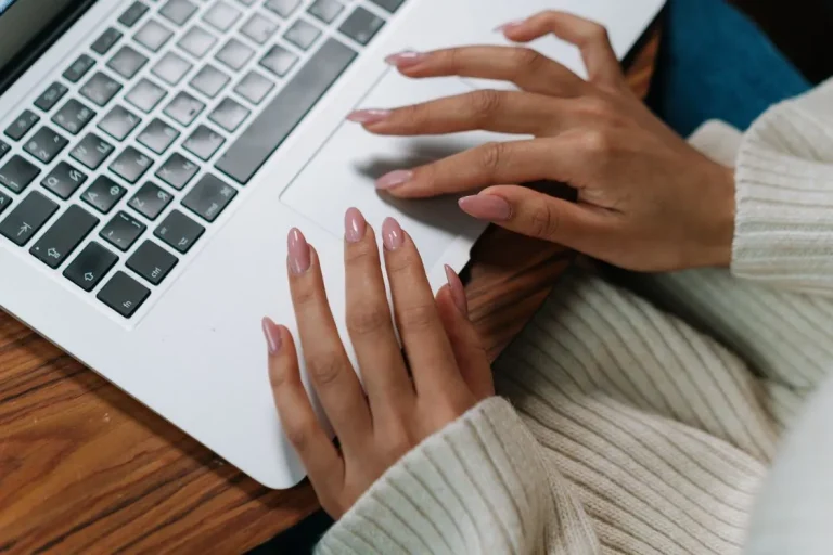 how to screenshot on laptop without printscreen button - hands typing on laptop keyboard