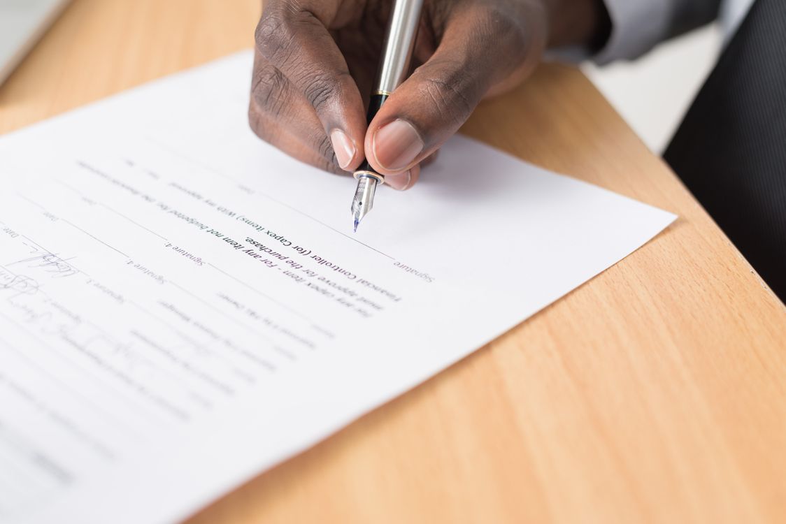 how much does it cost to form an llc - hand signing business formation documents