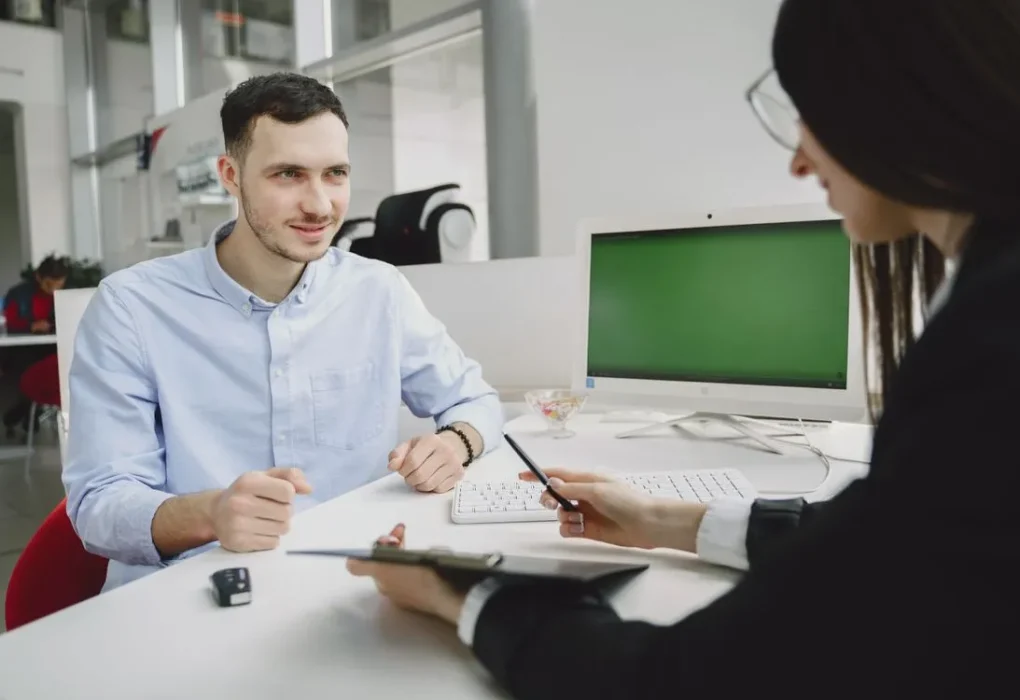 how to answer what are your weaknesses in an interview - job interview candidate talking with interviewer across a desk