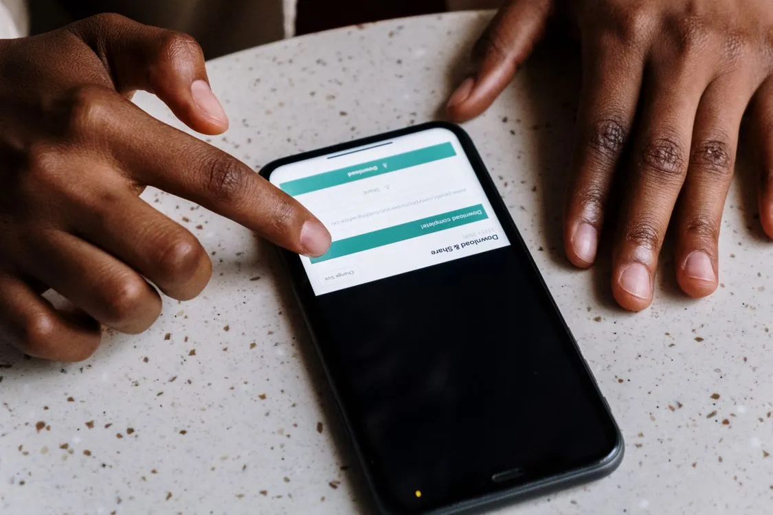 how to check screen time on iphone - hands using a smartphone checking screen time