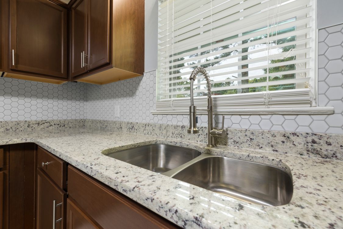 How to clean a garbage disposal: stainless steel kitchen sink in a modern kitchen