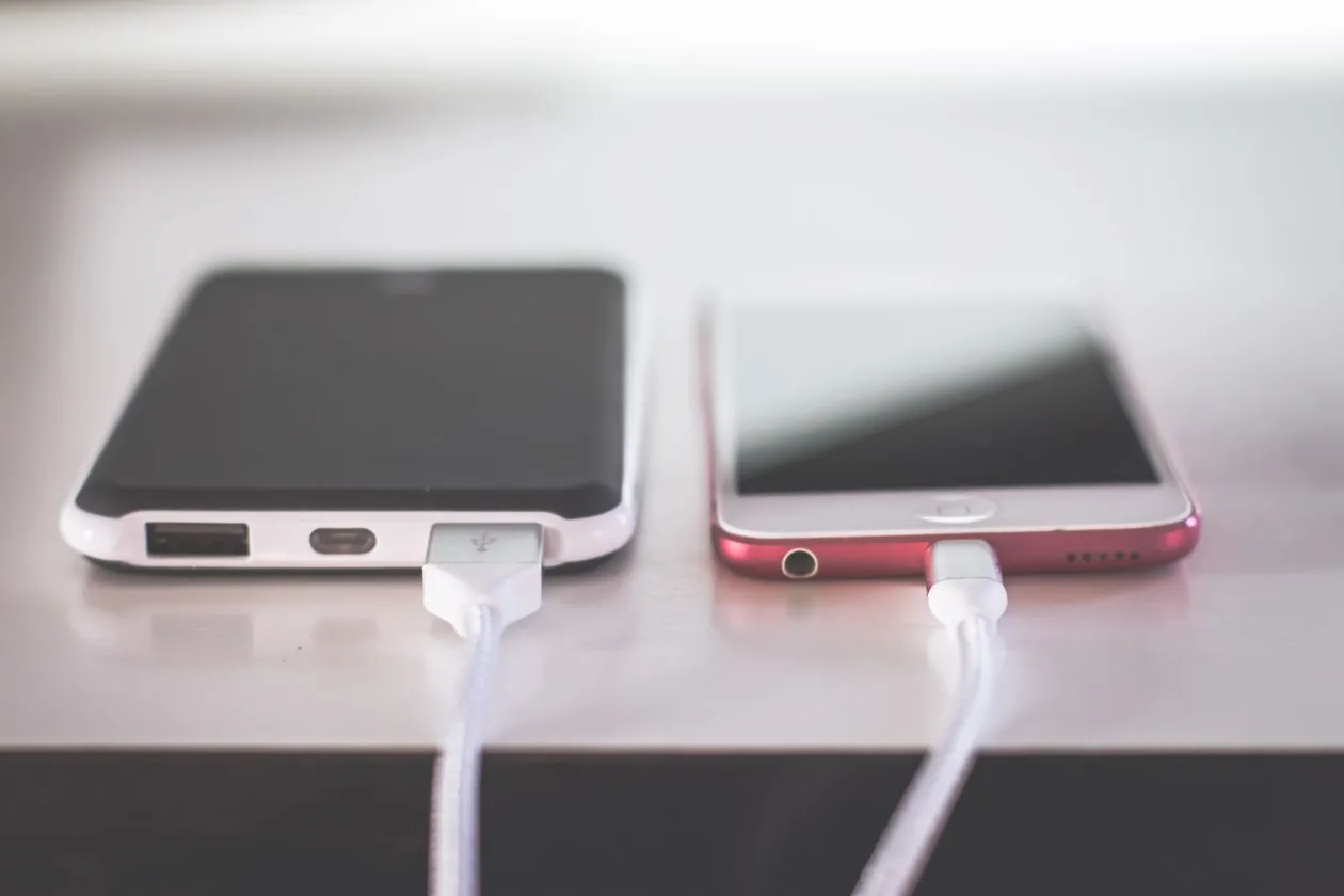 how to clean phone charging port - two smartphones plugged into charging cables