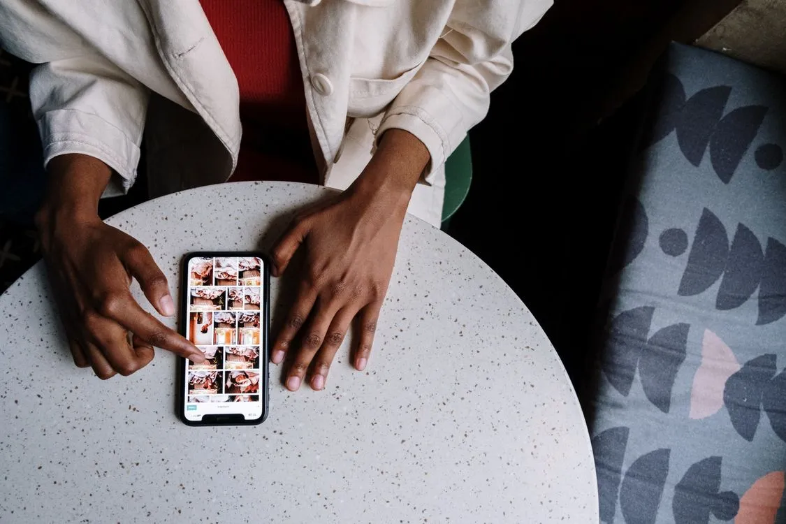 how to recover permanently deleted photos on iphone - overhead view of a person browsing photos on a smartphone