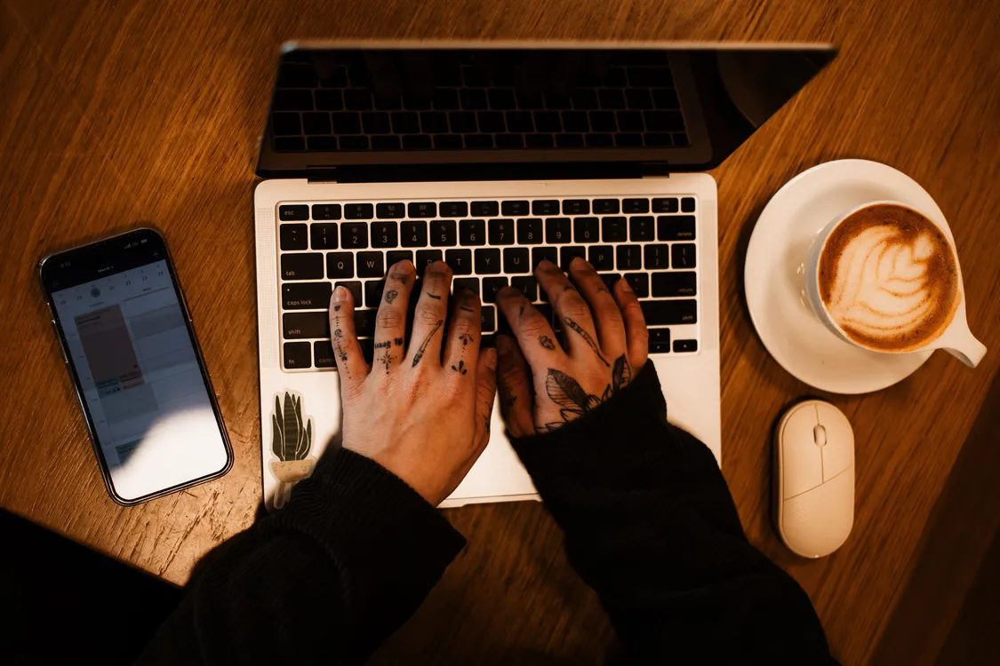side hustles to start with no money - freelancer working on a laptop at a home desk